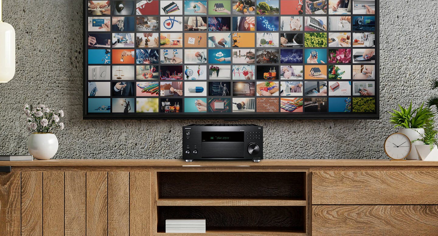 Onkyo TXRZ50 AV receiver under TV sitting on wooden dresser