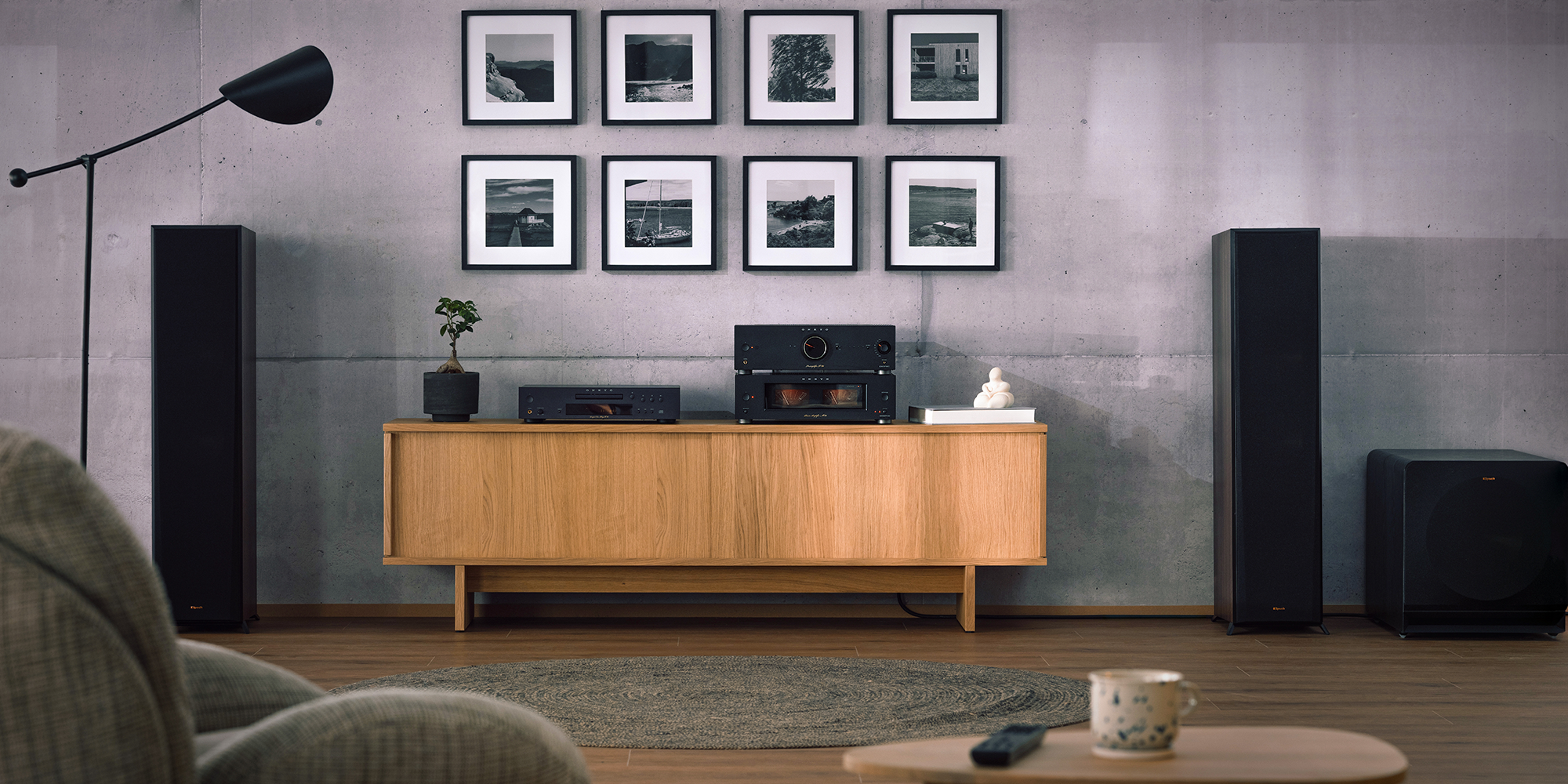 Onkyo Icon P 80 M 80 and C 30 black in listening room with Klipsch speakers gallery wall and lounge chair in blurred foreground 2000x1000