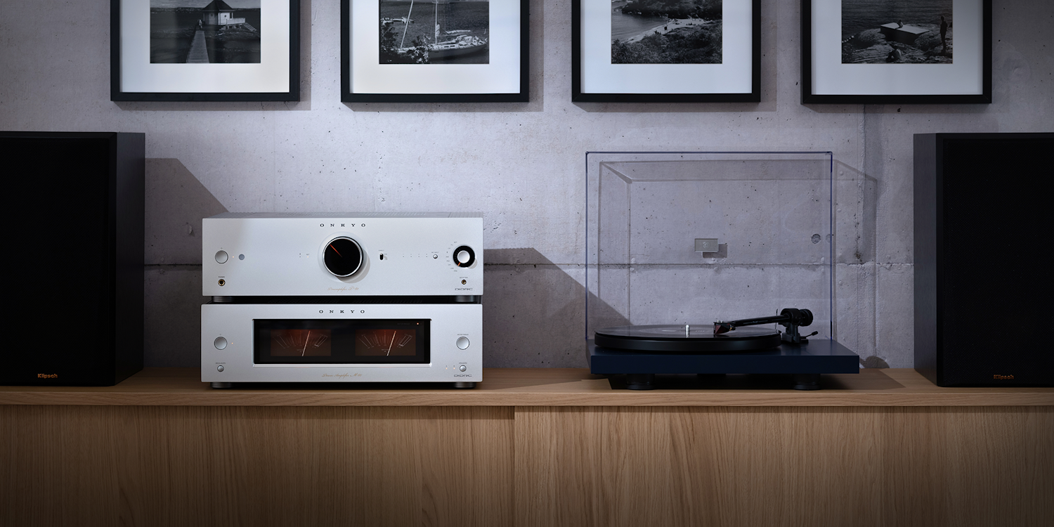 Onkyo Icon P 80 M 80 and turntable straight on between Klipsch bookshelf speakers on simple wood media console 2000x1000